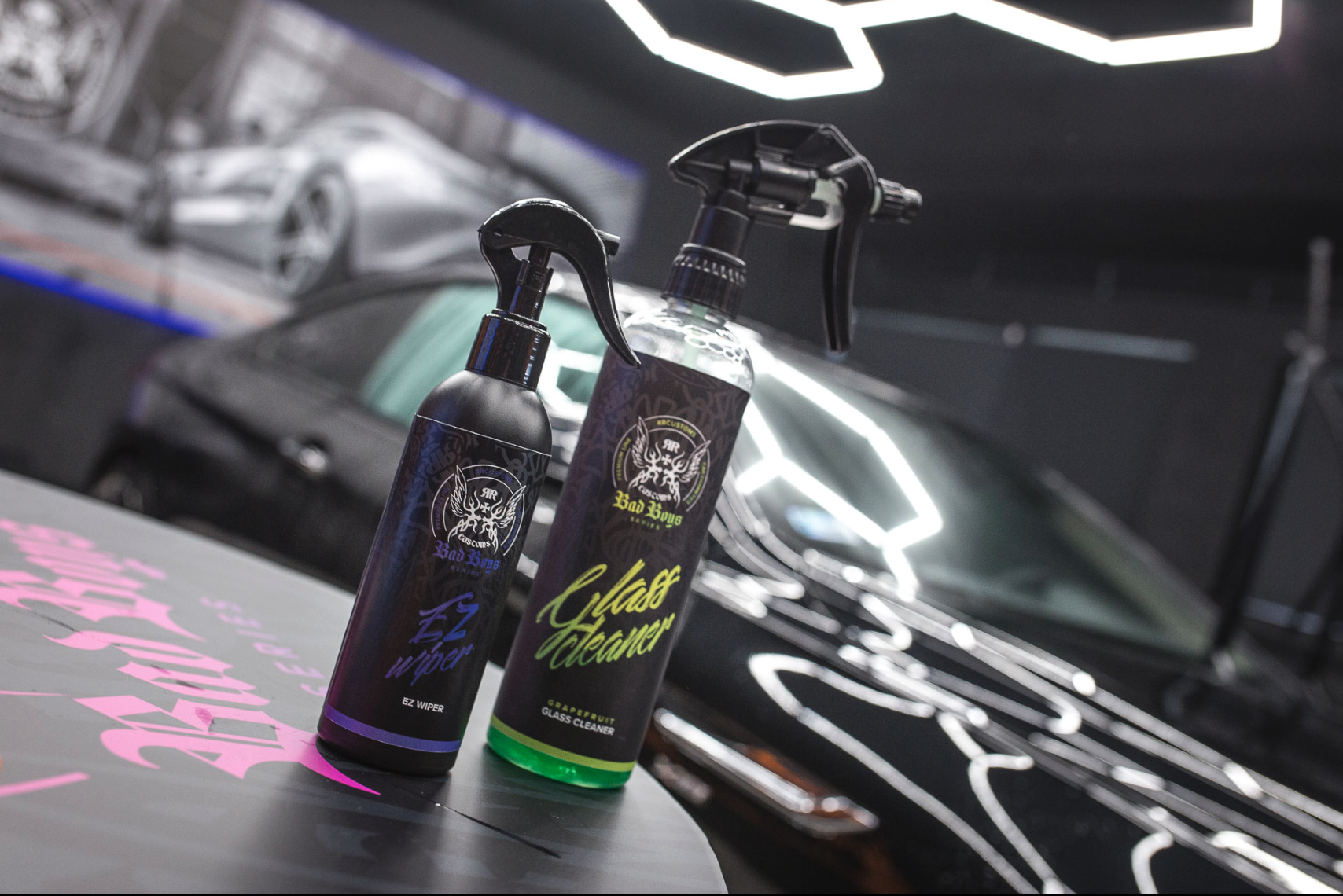 EZ Wiper – Group shot on dark car bonnet in neon-lit studio alongside Green Glass Cleaner bottle, showing product pairing | Car Glass | miio Store